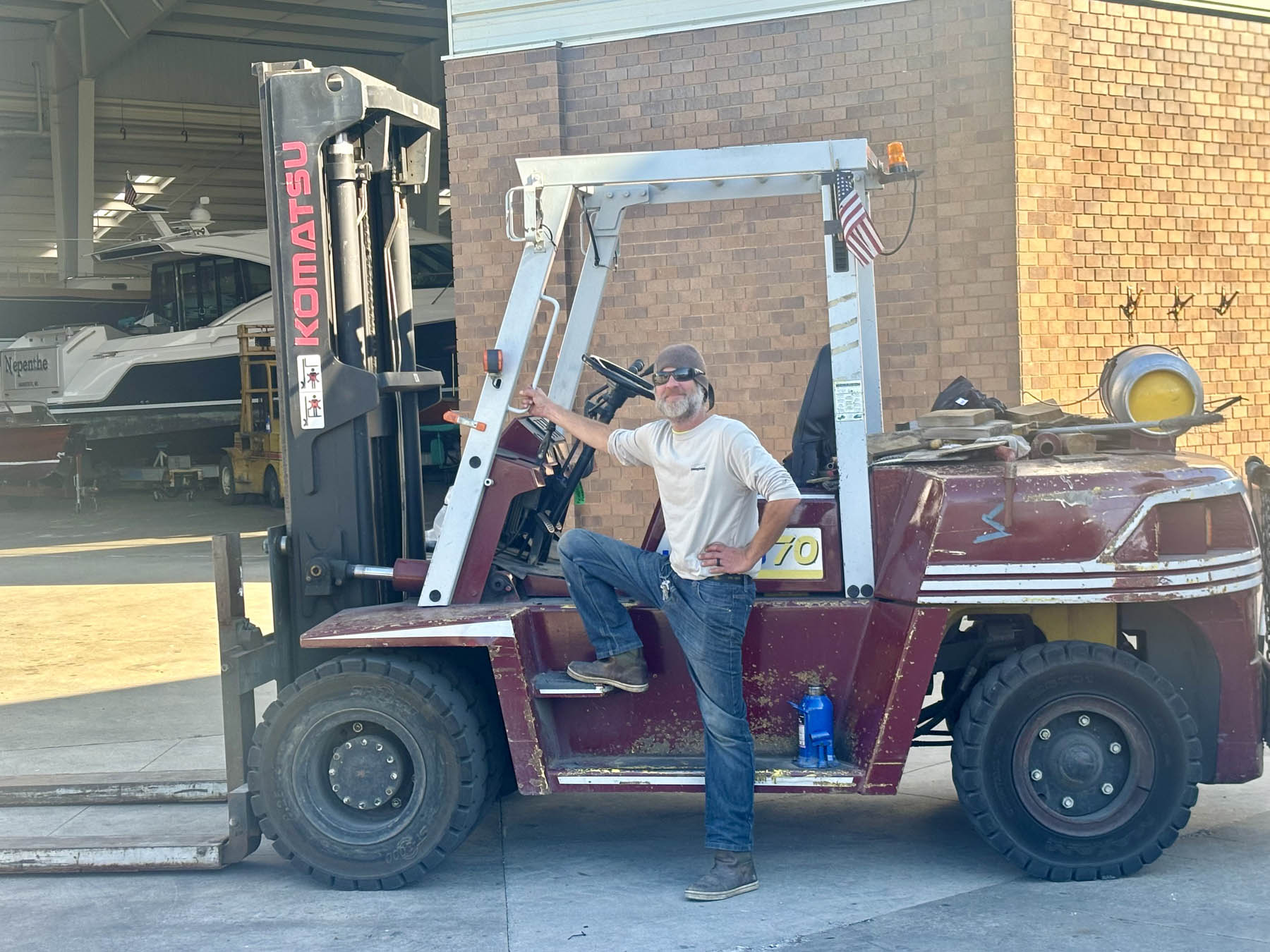 A yard forklift moving a boat at Eldean Shipyard